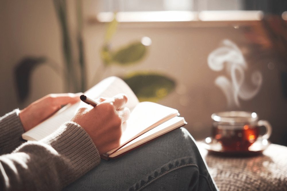 Person journaling emotions for emotional intelligence development.