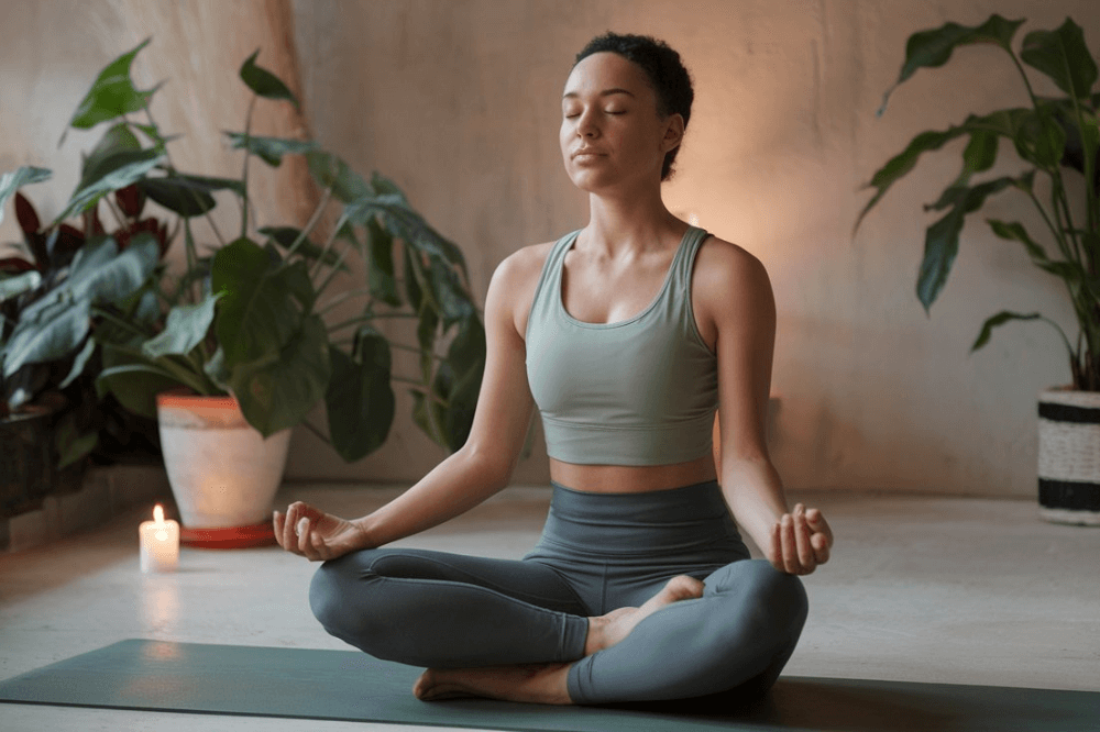 Woman practicing mindful breathing indoors for relaxation and stress relief.